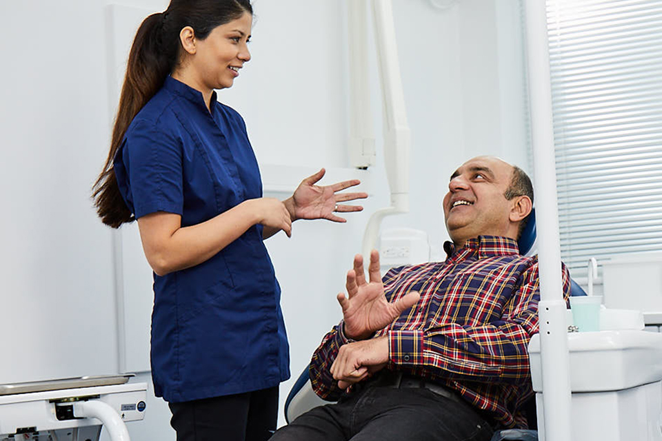 Nervous patient talks with dentist